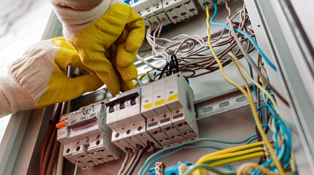 40373873-low-angle-view-of-electrician-in-gloves-fixing