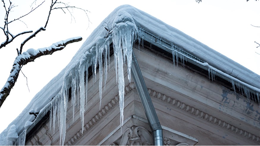 53587878-icicles-on-the-corner-of-the-roof-of-an-old-house