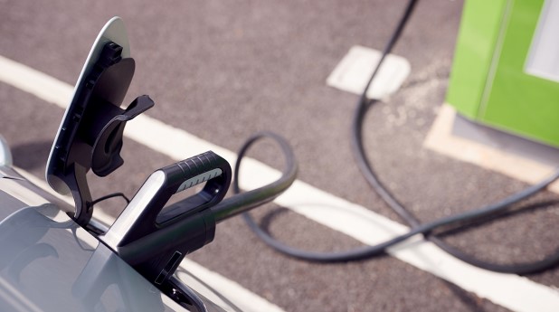 34388997-close-up-of-power-cable-charging-electric-car-outdoors